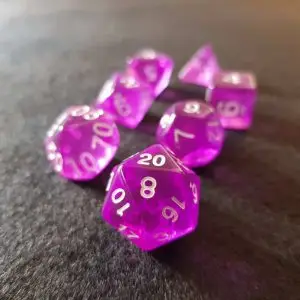 Amethyst RPG dice set: seven transparent purple polyhedral dice with white numbers on a dark grey felt surface