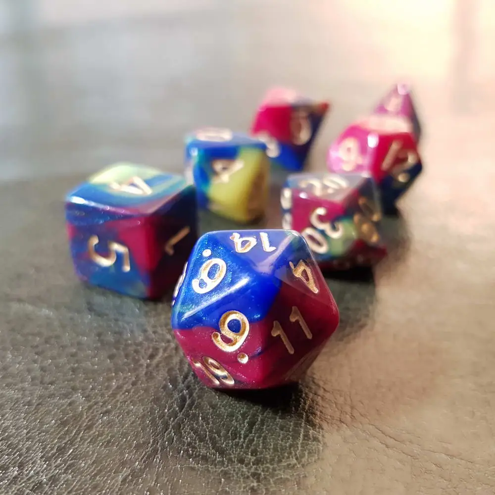 Distopia - RPG Dice Set 1 Distopia RPG dice set, seven polyhedral dice swirled in blue, magenta and yellow with gold numbers on dark leather