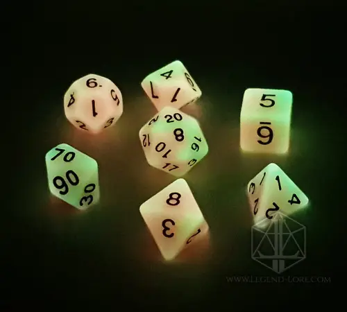 Persistent Twilight set of seven polyhedral dice glowing orange and green in the dark, with black numbers