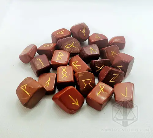 Cursed Spines Divination Runes: red jasper tumbled stones engraved with gold Elder Futhark runes on a white surface