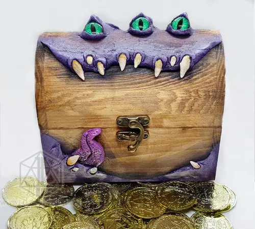 Mimic Boss - RPG Dice Box 3 Mimic Boss RPG dice box in brown wood with purple monster mouth, fangs, three green eyes and brass latch, gold coins in front