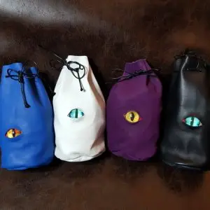 RPG ACCESSORIES - EN 4 Four Guardian Dice Pouch leather drawstring bags in blue, white, purple and black, each with a reptilian dragon eye