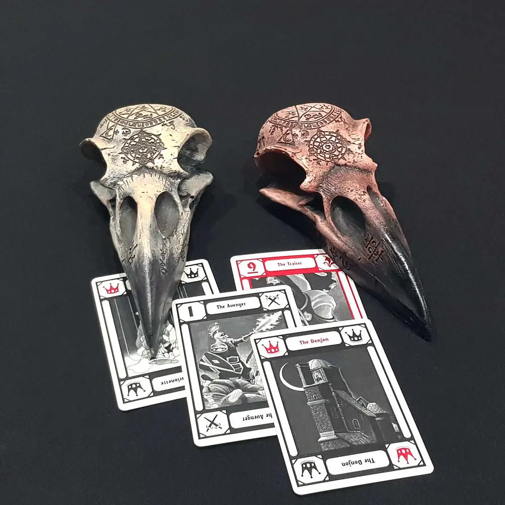 Raven Skull divinatory items in bone white and red resin with carved runes, beside black and white tarot-style cards