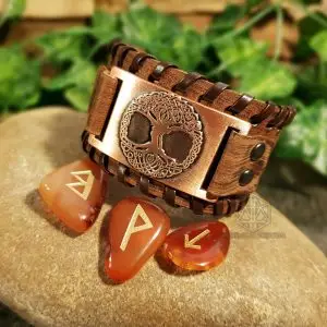 Gift of the Ancient Tree Viking bracelet: brown leather cuff with copper Celtic Tree of Life plate beside carnelian rune stones