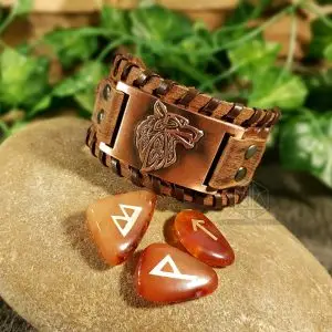 Bracelet of Wild Pack: brown laced leather cuff with copper plate bearing a Celtic knot wolf head, beside carnelian rune stones